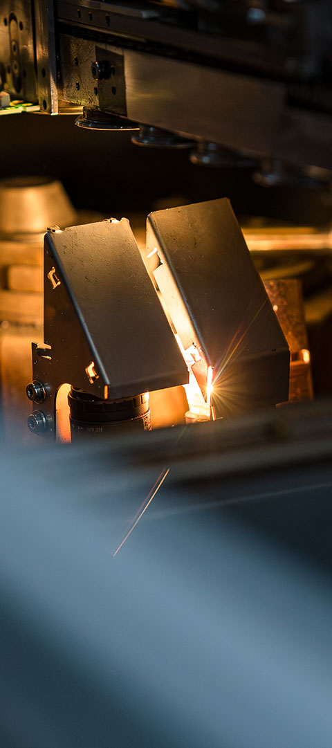 Detailaufnahme eines THT-Lötvorgangs mit präzisem Lichtpunkt während der Produktion